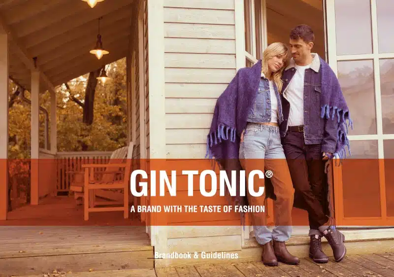 Gin Tonic Brandbook Cover für Casual Wear mit zwei Models in sportlich-urbaner Kleidung und orangefarbener Markenfläche mit Logo und Claim.